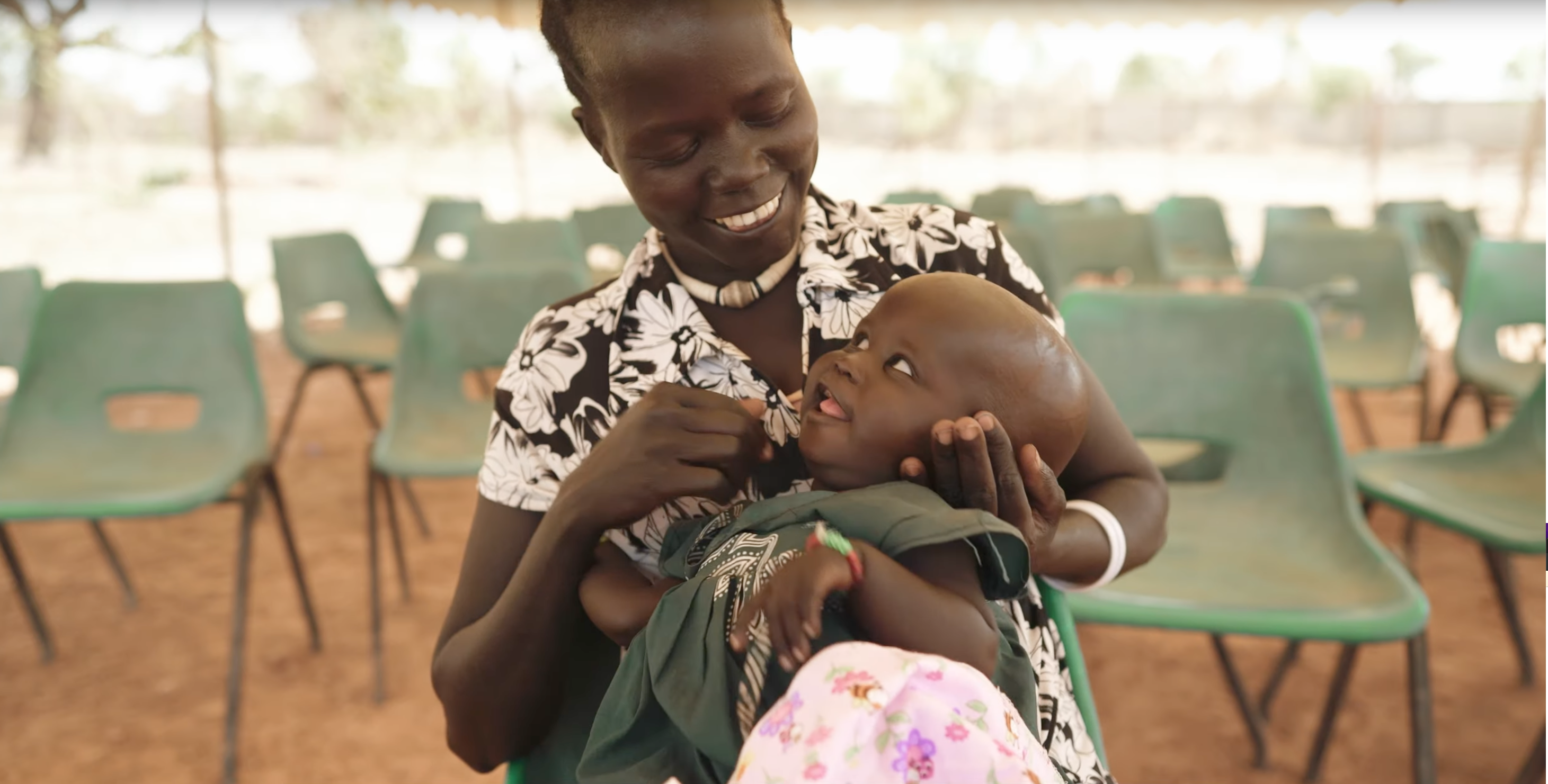 Mother holding her infant and smiling